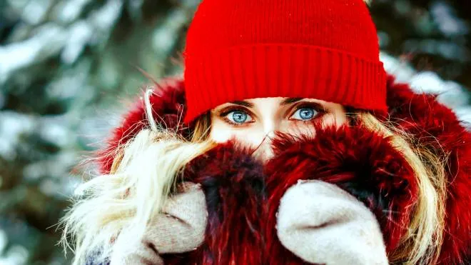 woman in winter hiding in a scarf against the cold FREDDO POALRE GUANTI CUFFIA SCAIRPA